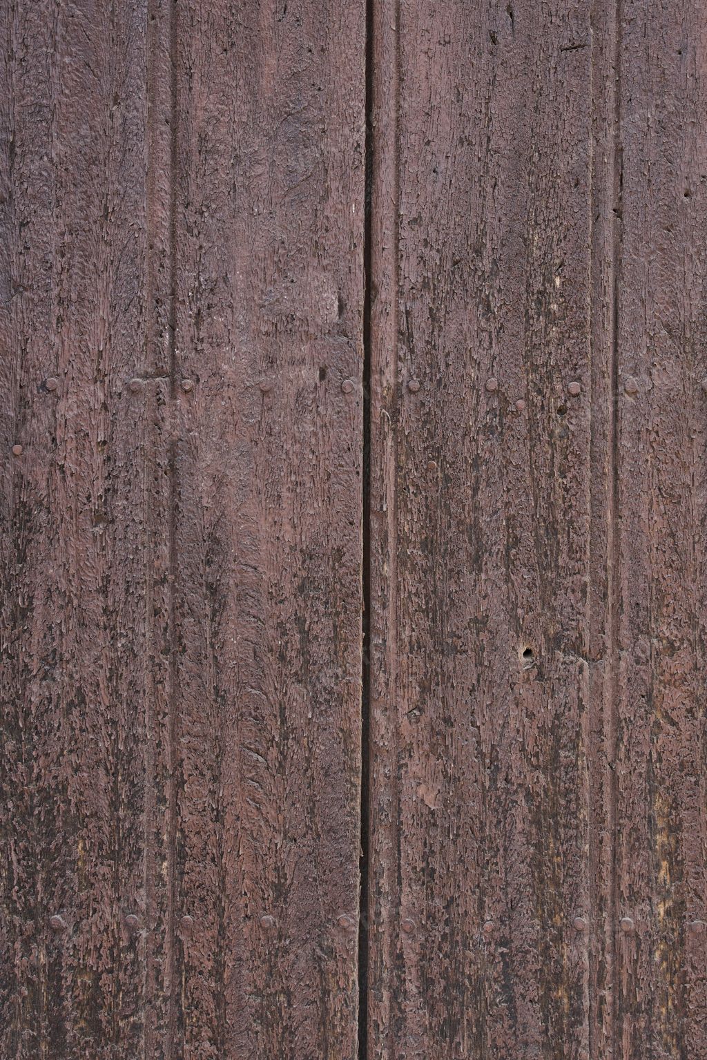 Old wooden texture of windows and doors weathered by time with cracks and rusty nails