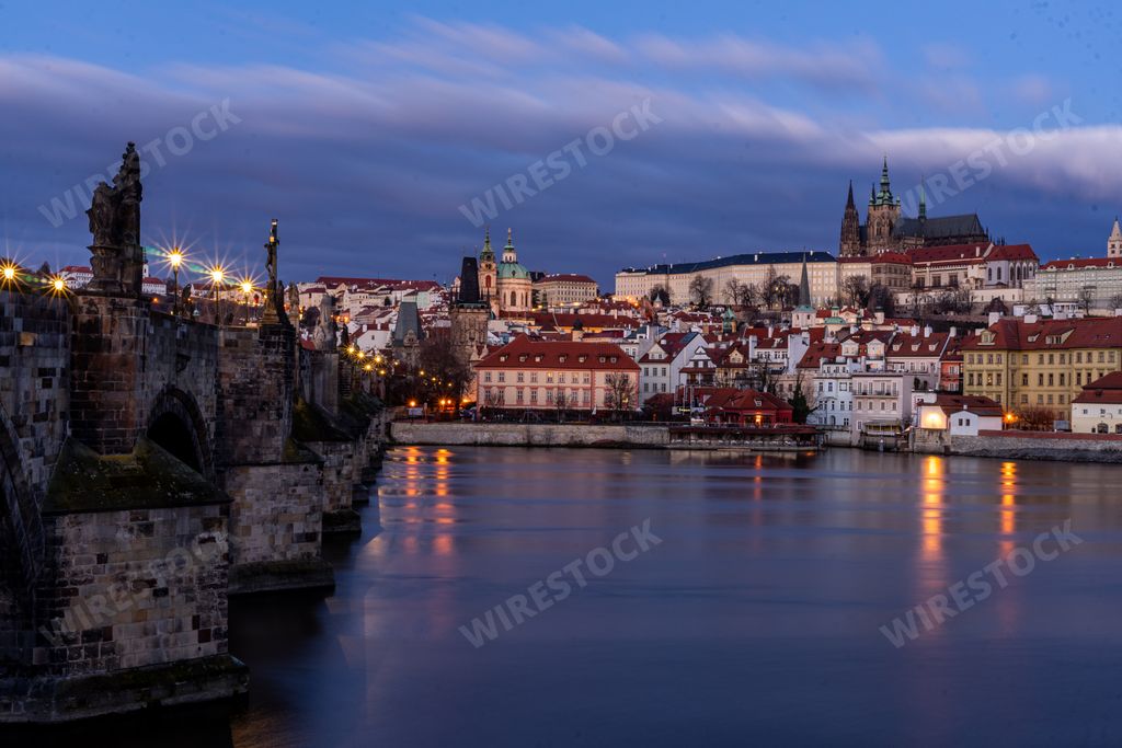 A beautiful shot of sunrise over Vltava River near Charles Bridge and the Old Town of Prague