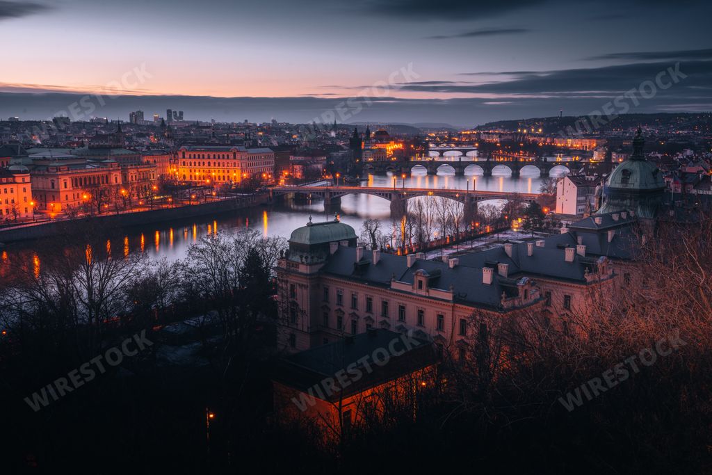 An aerial view of a bright sunset over Vlatva River and the Old Town of Prague