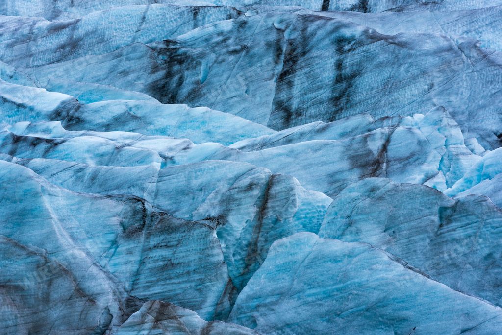 A closeup shot of an iceberg in an ocean during the day