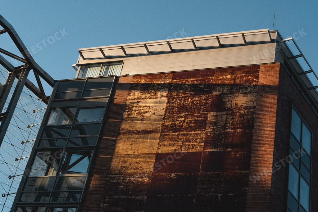 A low angle shot of a modern building with color side wall on a clear day