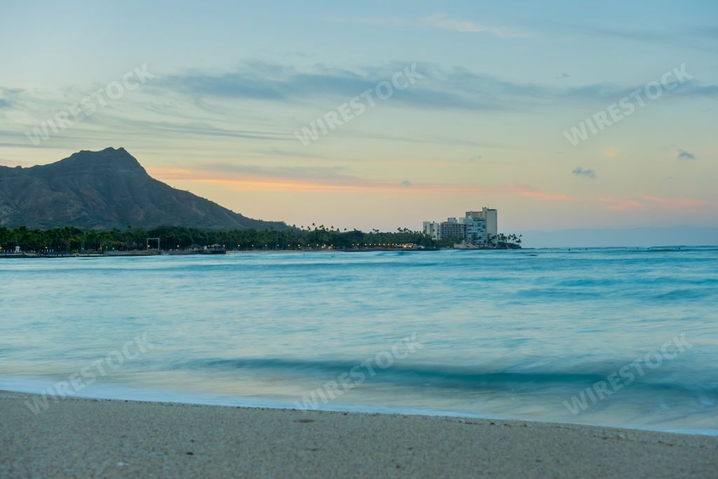 A high angle shot of Waikiki Beach sunrise with Diamond Head in the background