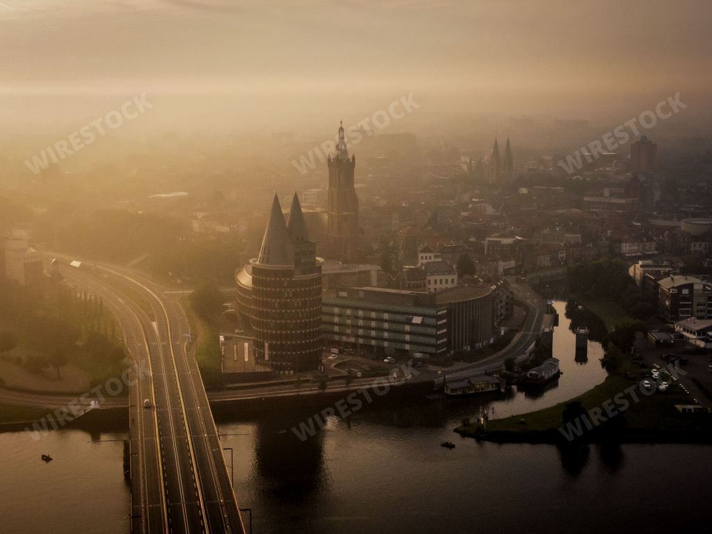 An aerial view of Roermond cityscape at foggy sunset in Netherlands