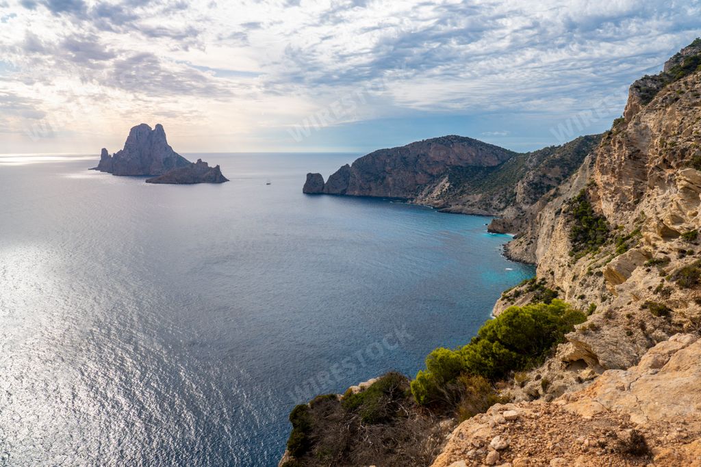 An aerial view of a beautiful sunset in Es Vedra island from Cap Llentrisca, Spain