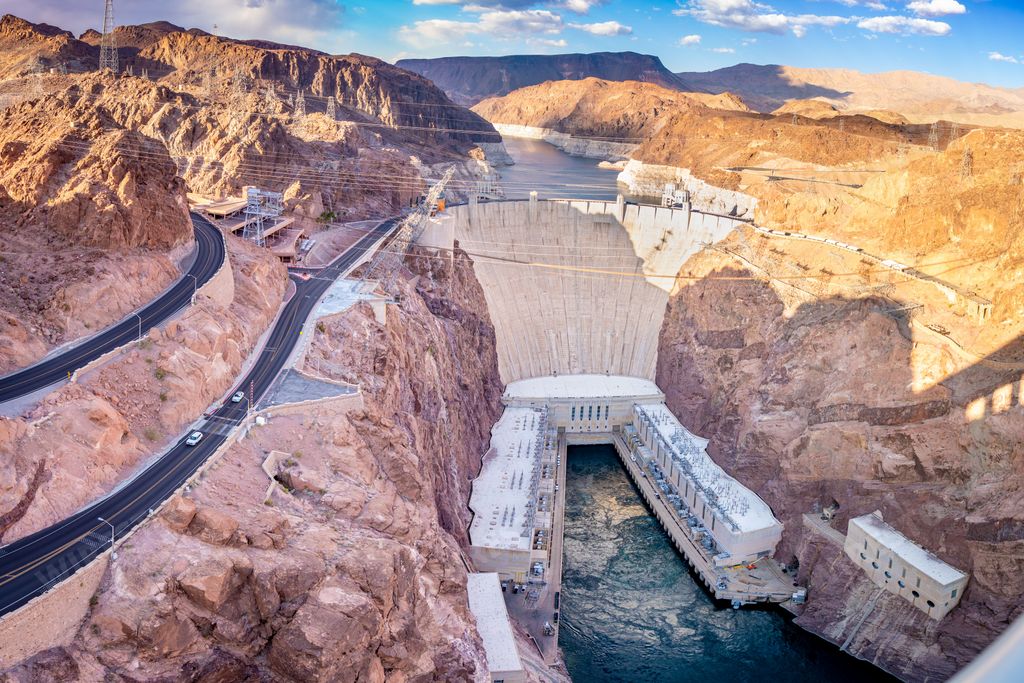 A high-angle shot of a  sunset at the Hoover Dam from the Memorial bridge