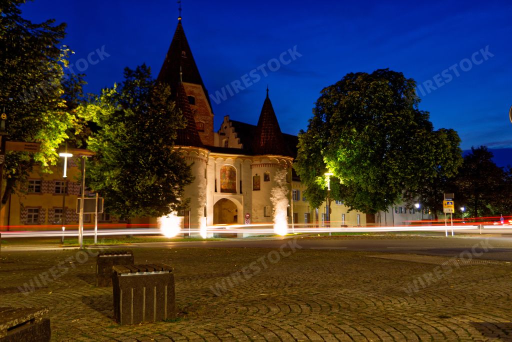An old castle-like building and fountains with backlights in Weissenhorn, Bavaria, Germany