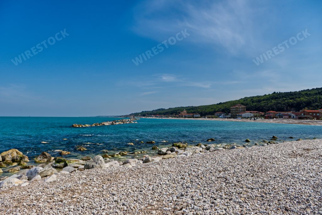 A beautiful rocky beach with turquoise calm water in Italy