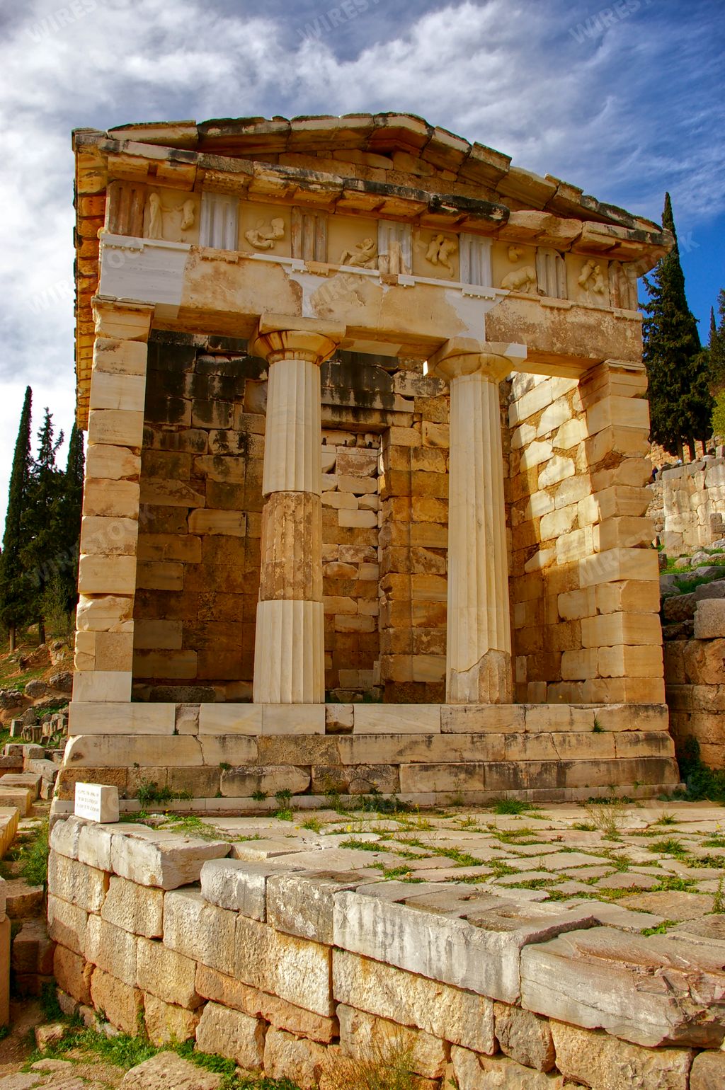 A vertical shot of the Athenian Treasury in Delphi, Greece