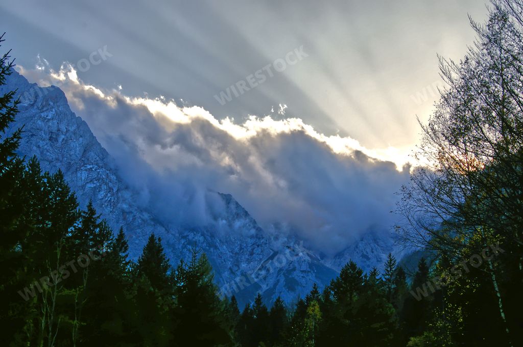 A beautiful view of cloudy mountain and treetops in Logarska Dolina settlement, Logar Valley, Slovenia