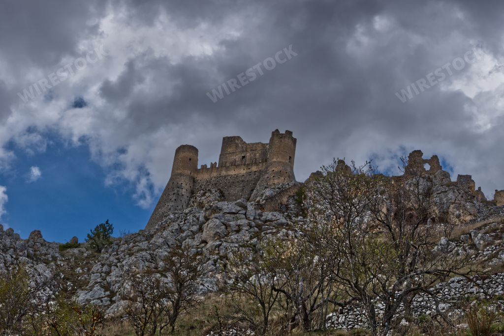 A low angle view of an abandoned castle on the hill on a gloomy day