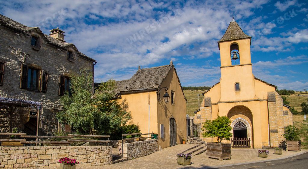 A beautiful shot of an old chapel near houses in Champerboux village in Lozere, France, Europe