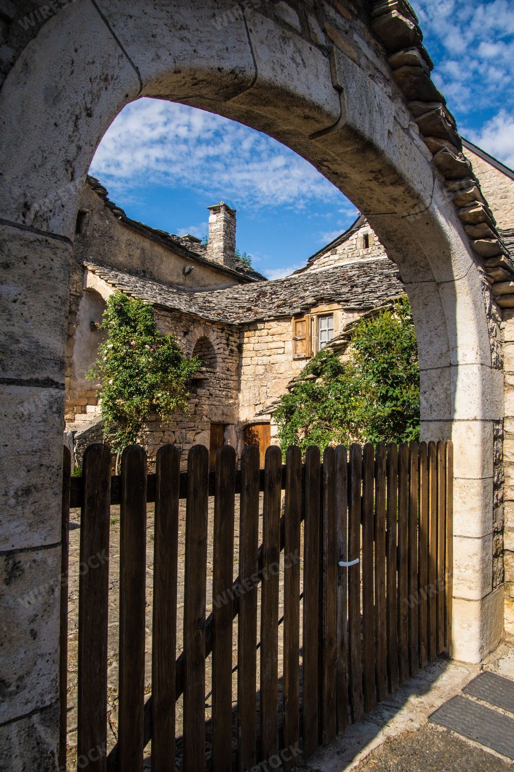 A beautiful shot of a fenced old stone house in Champerboux village in Lozere, France, Europe