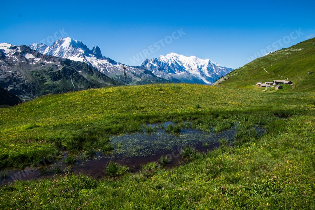 A landscape of wet grass hills and houses in charamillon gondola alps in Haute Savoie, France