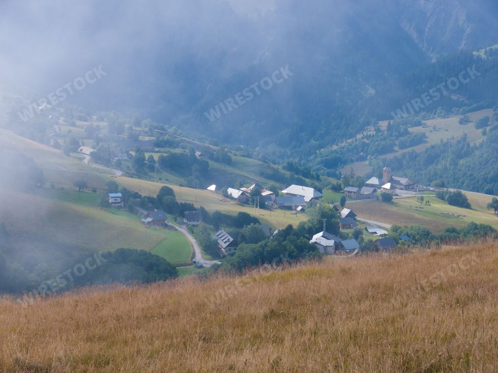 A scenic landscape with mountains and countryside houses in Saint Jean d'Arves, Haute Savoie, France