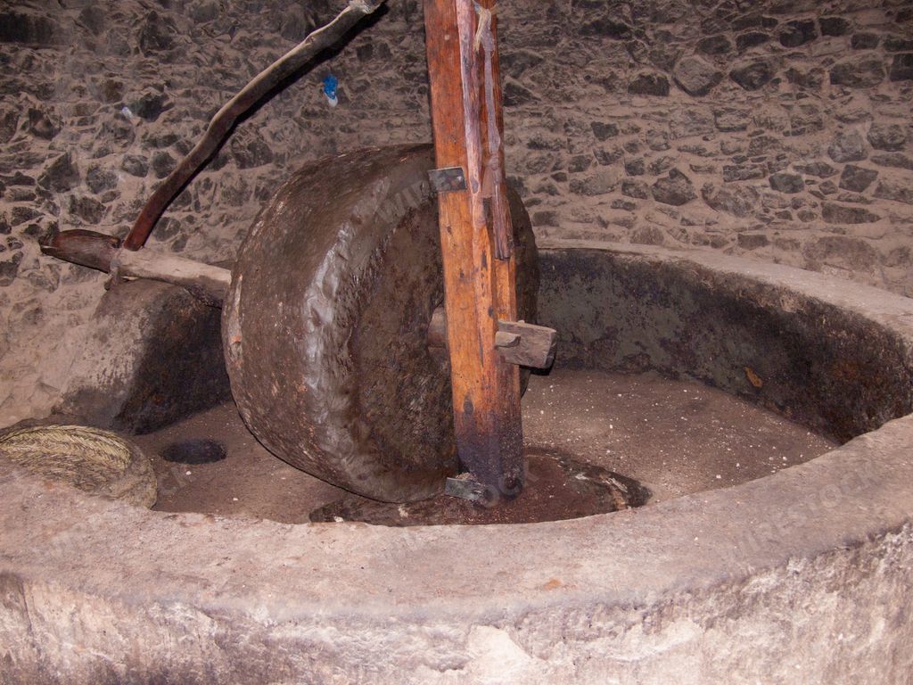 A closeup shot of a vintage Ox cart wheel pn a rocky land in Agadir, Morroco