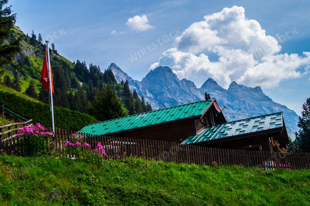 A beautiful view of mountain landscapes and small houses under the cloudy sky