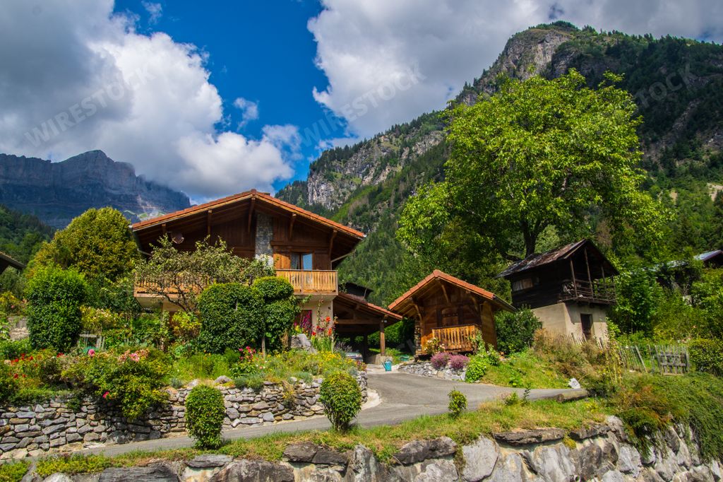 A beautiful view of a wooden house surrounded by the mountains in France