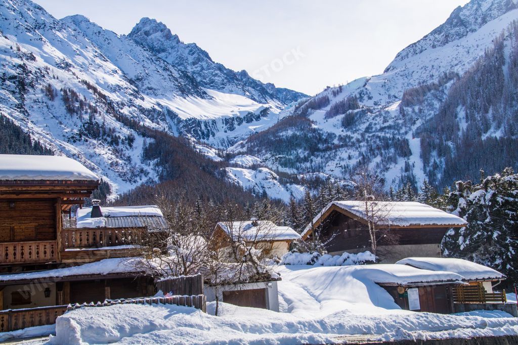 A landscape view of the snow-capped wooden houses and mountains. Argentiere, Chamonix, Mont Blanc