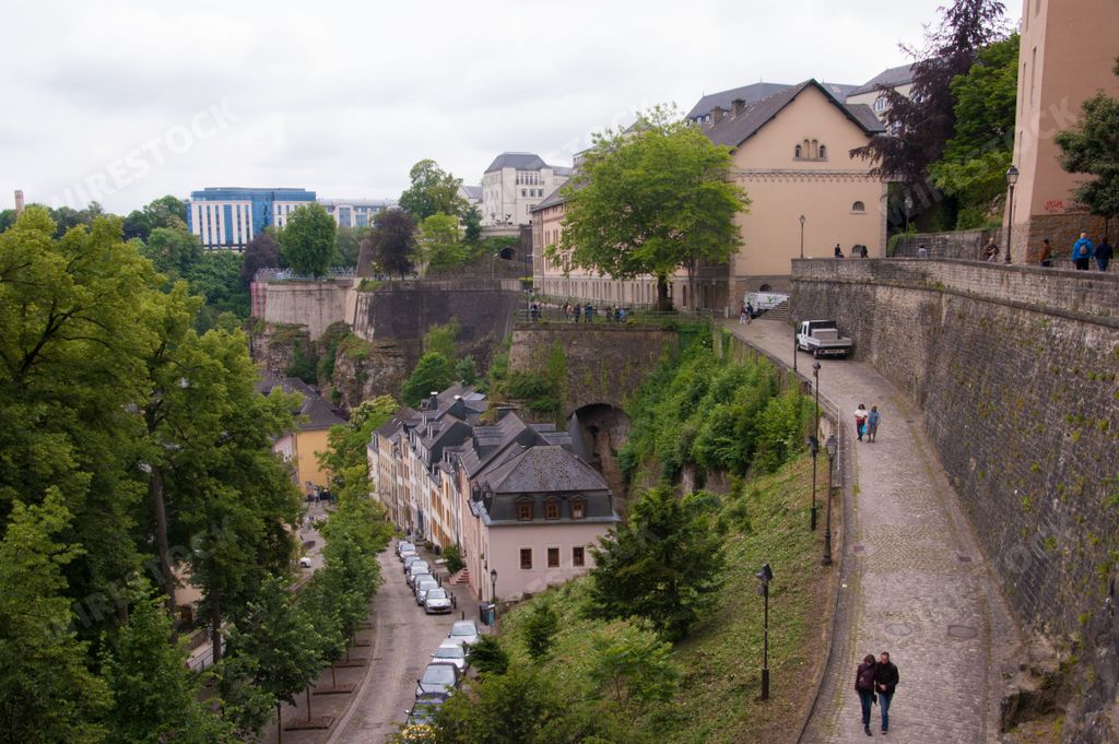 An aerial view of cityscape Luxembourg surrounded by buildings with people walking