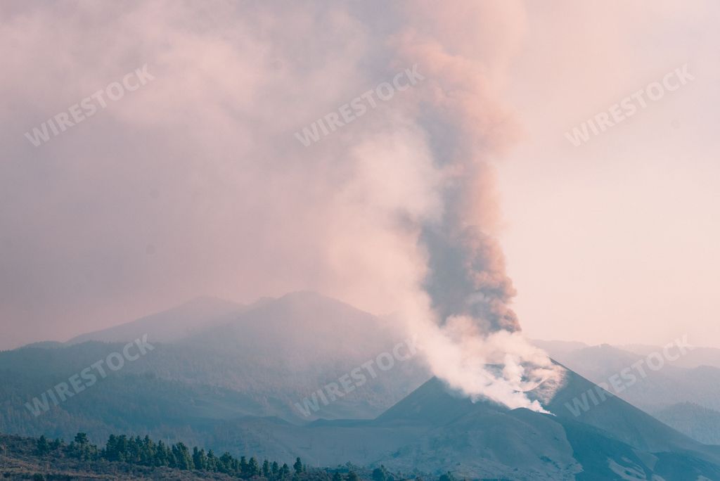 Thick steam coming out of the top of a volcano mountain
