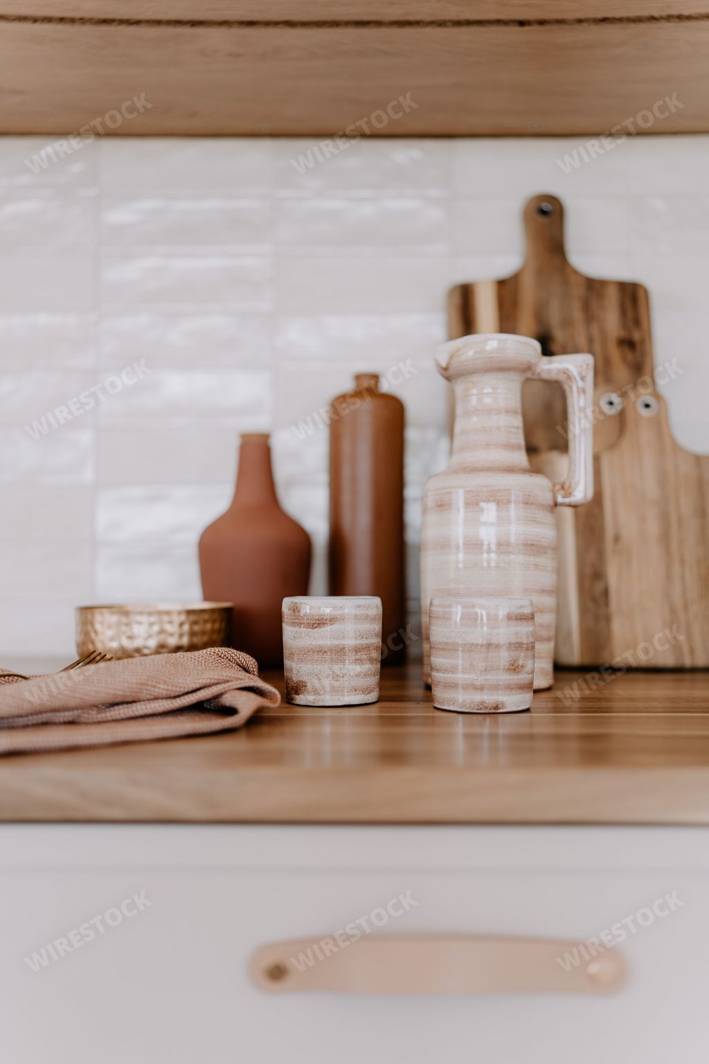 A rustic kitchen countertop with a selection of ceramic pots and bowls on display