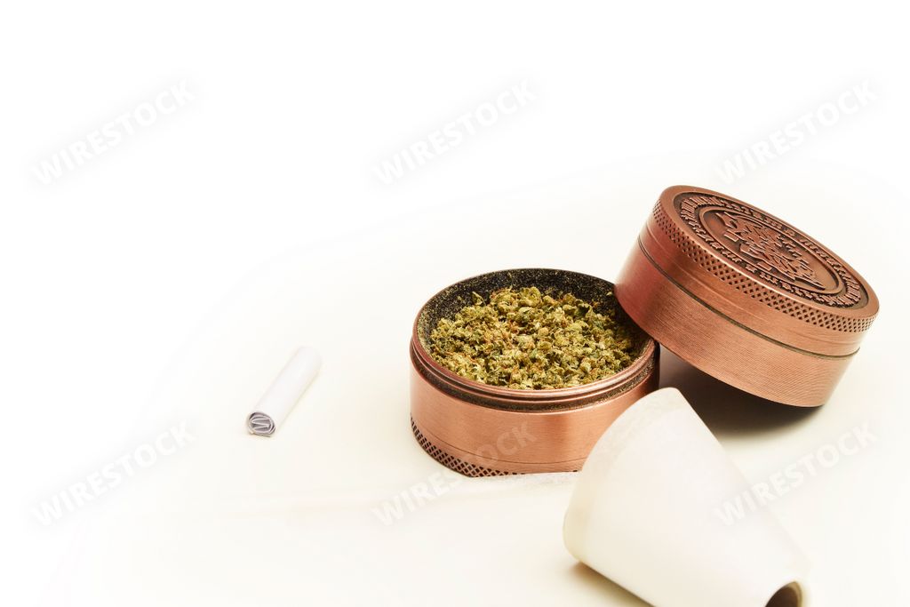 A grinder with cannabis isolated on a white background with space for text