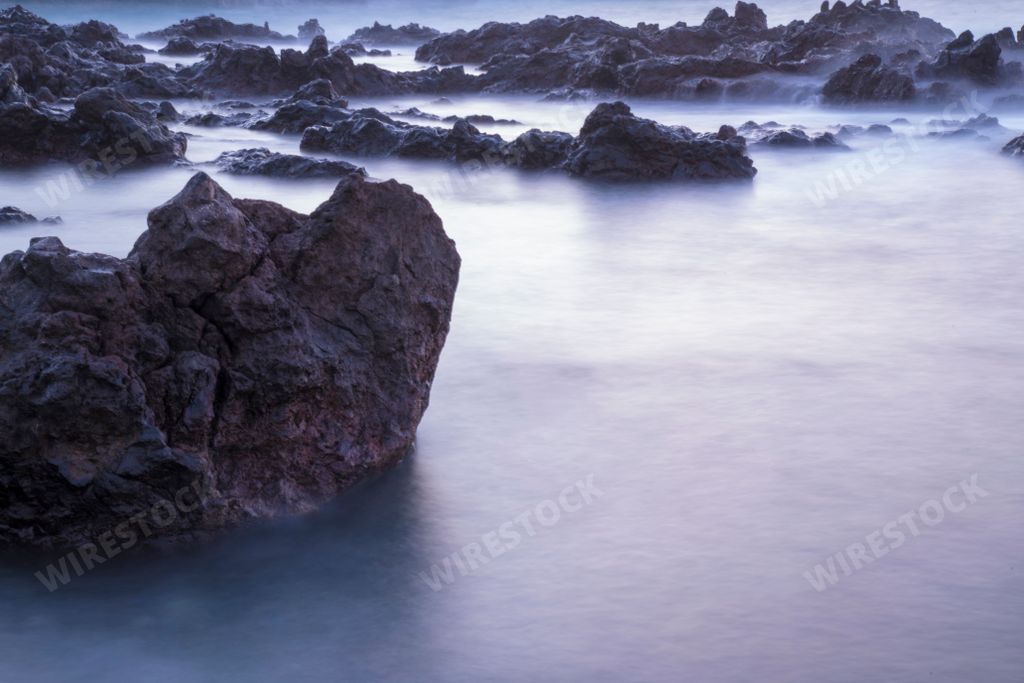 Shallow water with rocks with long exposure fog