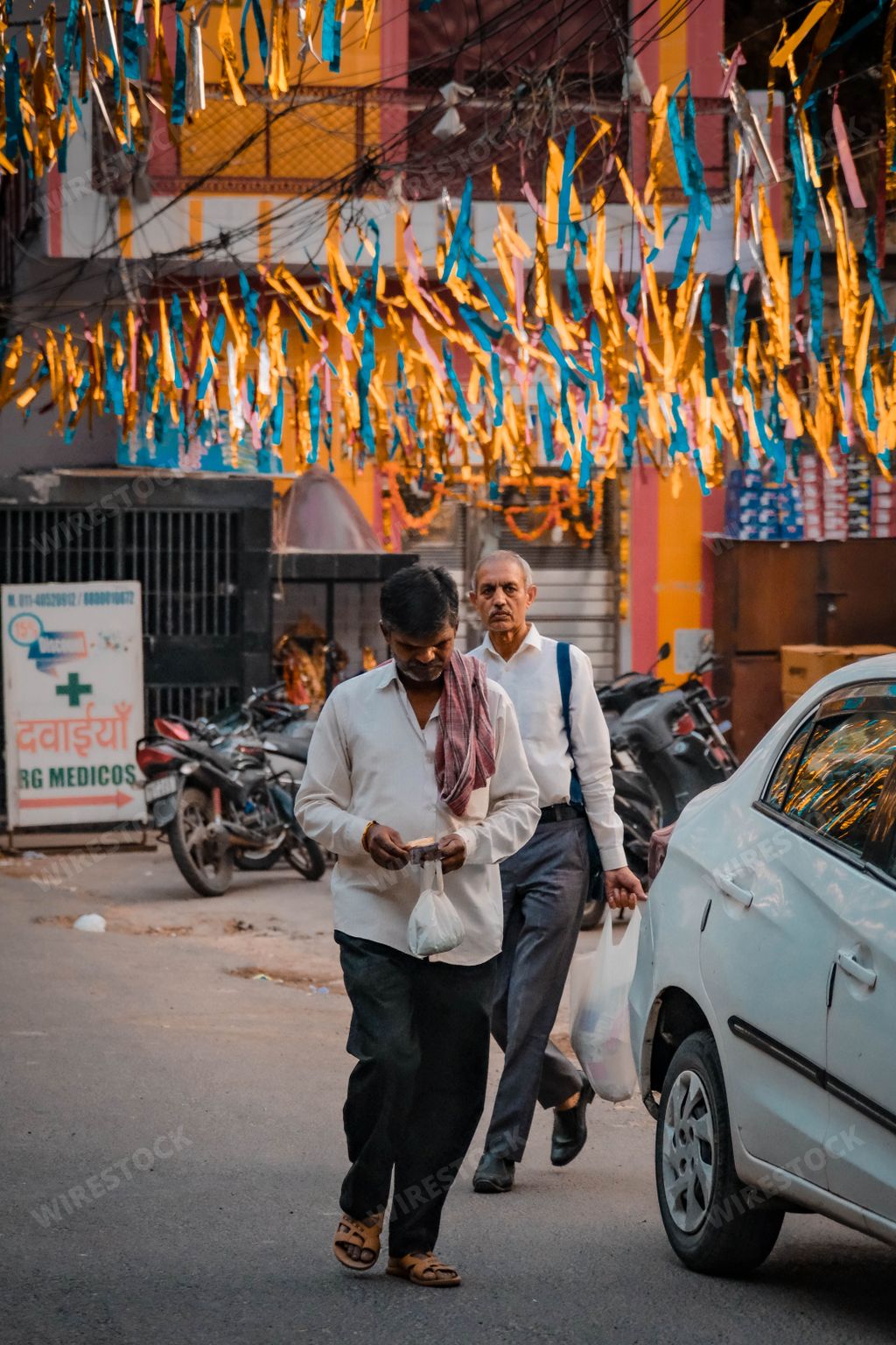 A vertical shot of people in the busy streets of Delhi
