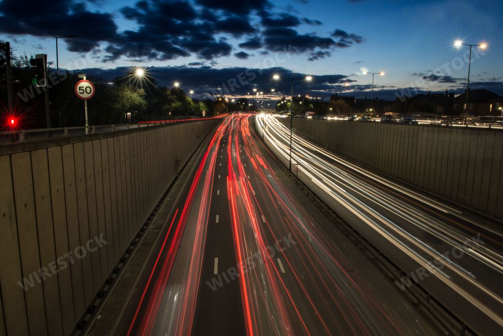 Light trails from fast moving traffic on the A40 at Perivale in London. The quick moving cars leave light trails, giving the illusion of speed.