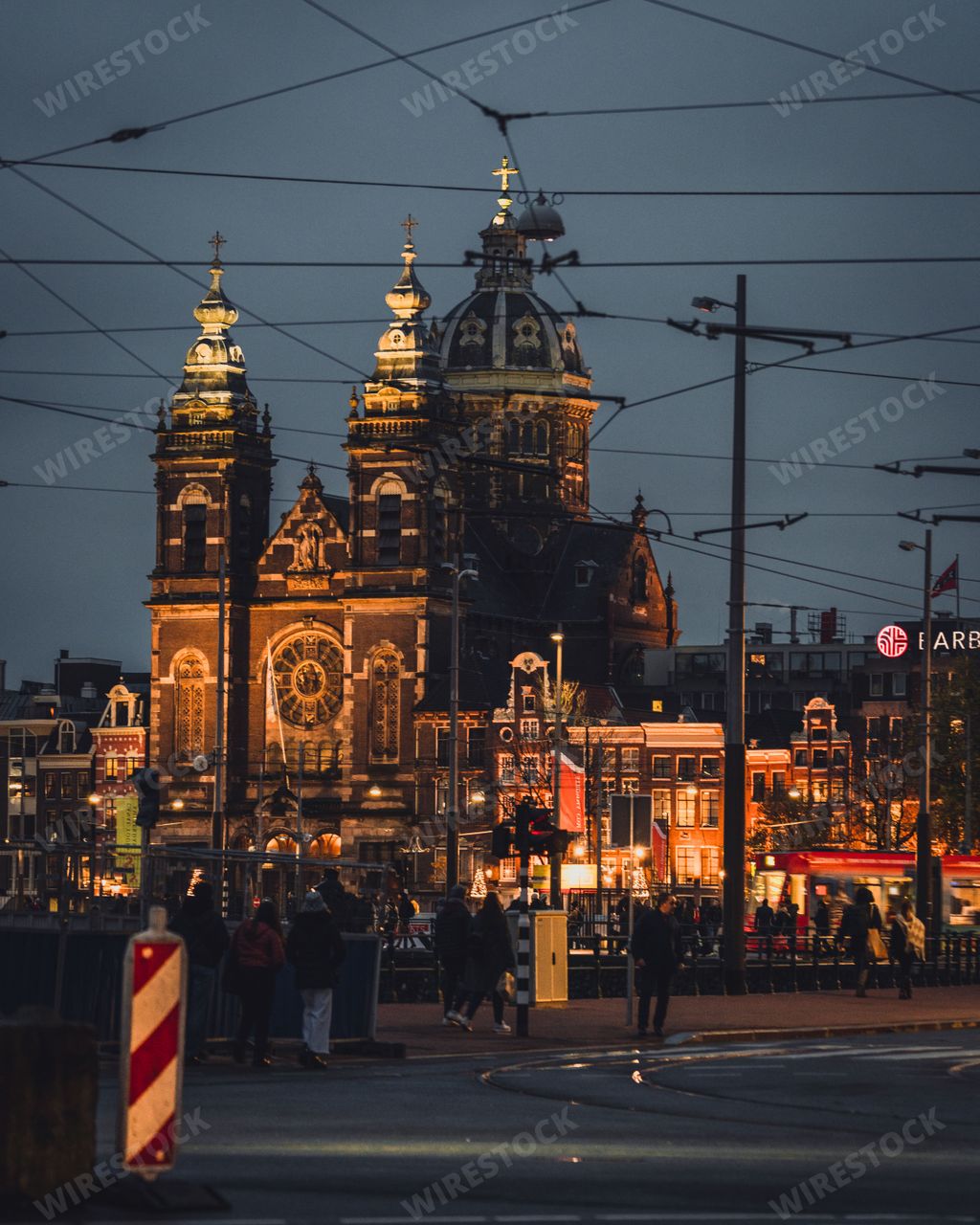 Amsterdam, Netherlands - November 27 2022: The Basilica of St Nicholas at night. The Famous cathedral is lit with warm street lighting.