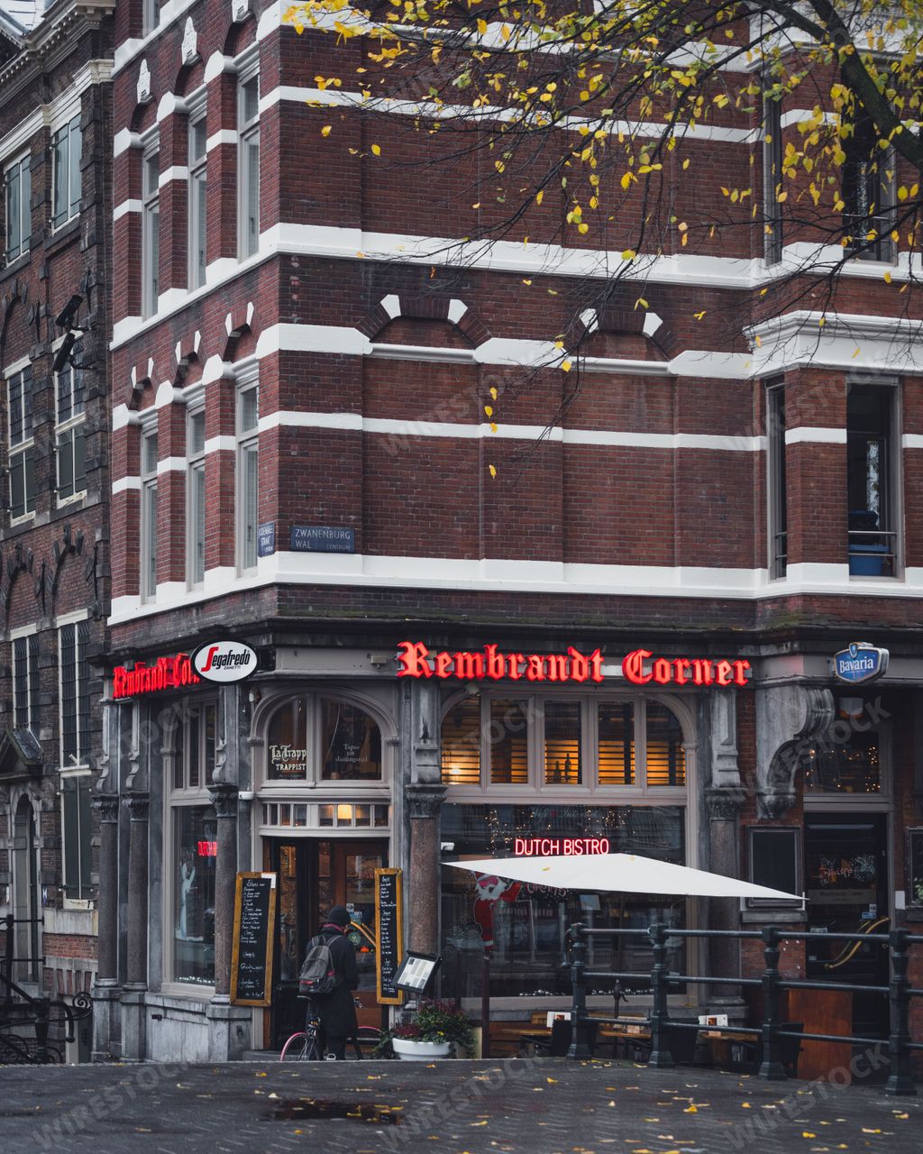 Amsterdam, Netherlands - November 27 2022: Rembrandt Corner cafe and restaurant on a street corner in Amsterdam on an autumn day.