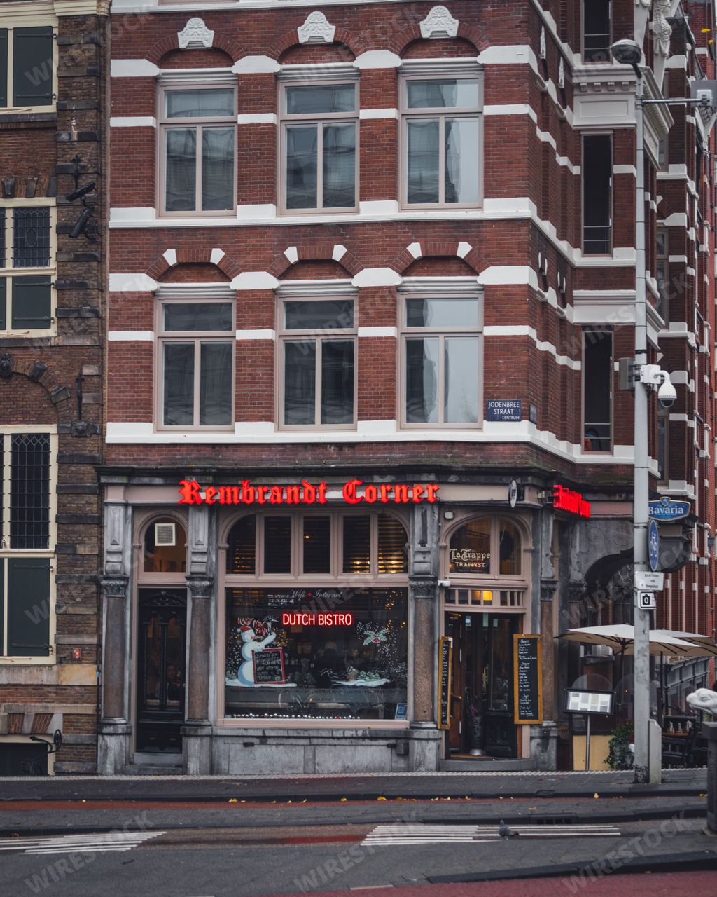 Amsterdam, Netherlands - November 27 2022: Rembrandt Corner cafe and restaurant on a street corner in Amsterdam on an autumn day.