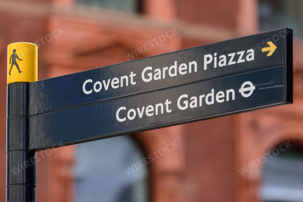 A street sign in the west end of London, UK gives directions to pedestrians who are heading towards Covent Garden