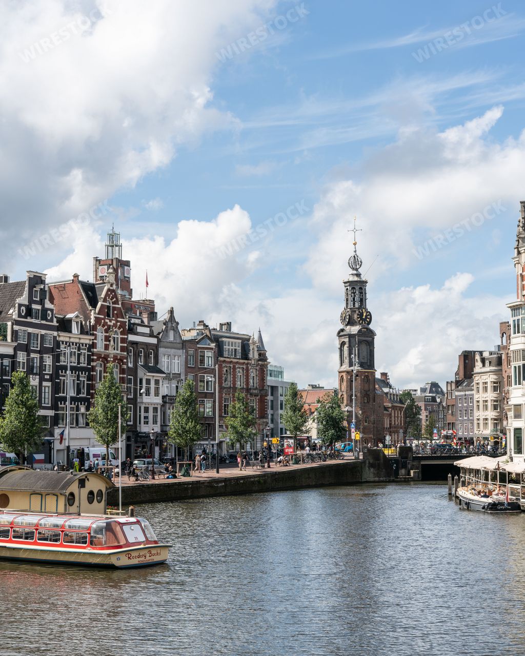 Amsterdam city center, showing the Amstel River and Munttoren tower in the background.