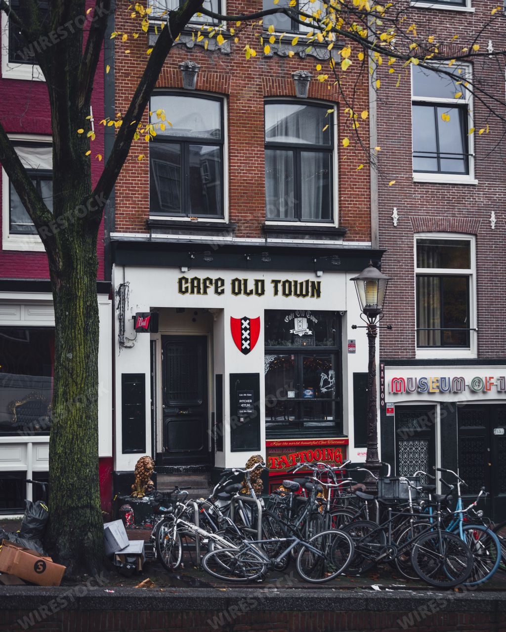 Amsterdam, Netherlands - November 27 2022: Bicycles parked outside Cafe Old Town, a bar in the red light district of Amsterdam.