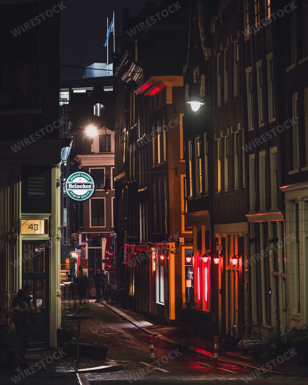 A side street in the De Singel red light district of Amsterdam at night. Red lights show the window brothel