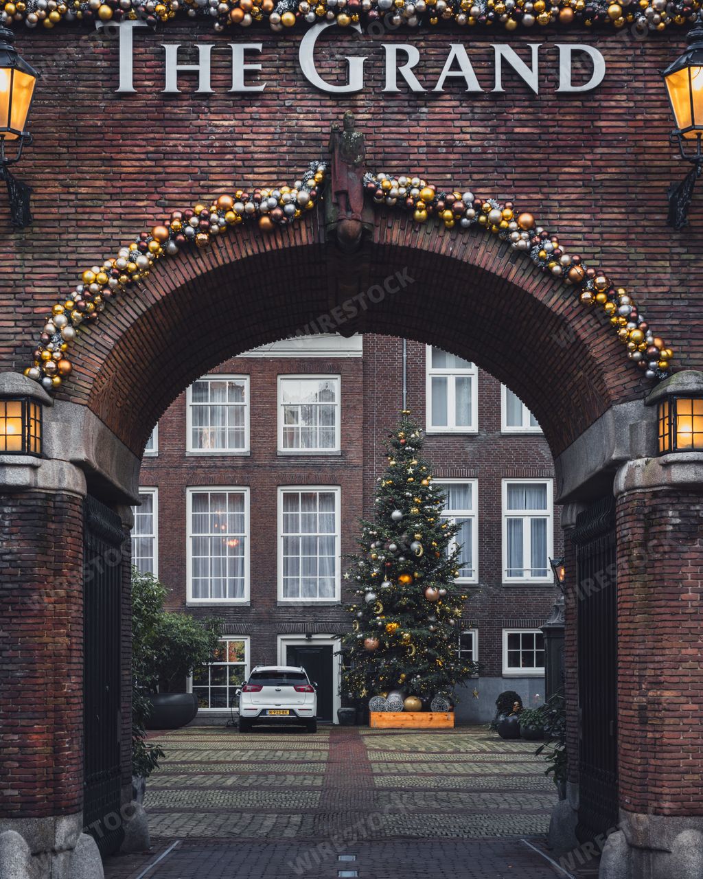 Amsterdam, Netherlands - November 28 2022: A Christmas tree and decorations adorn The Grand hotel in Amsterdam during the winter.