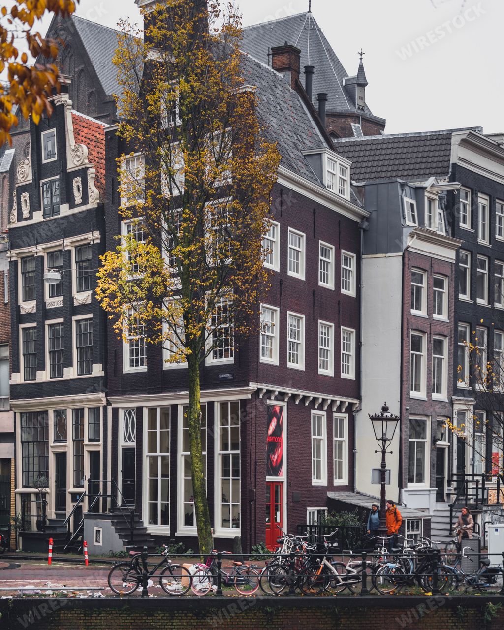 Amsterdam, Netherlands - November 28 2022: A street scene in Amsterdam at the side of the Singel canal in the city centre.