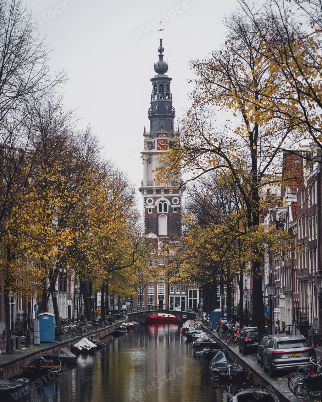 Amsterdam, Netherlands - November 27 2022: A famous view of the Zuiderkerk Tower in Amsterdam. Taken from a bridge over a canal.