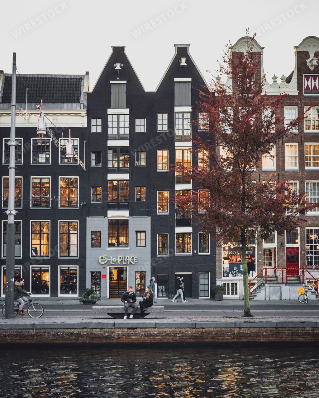 The classic tall Amsterdam houses next to a canal in the city center in Amsterdam, Netherlands