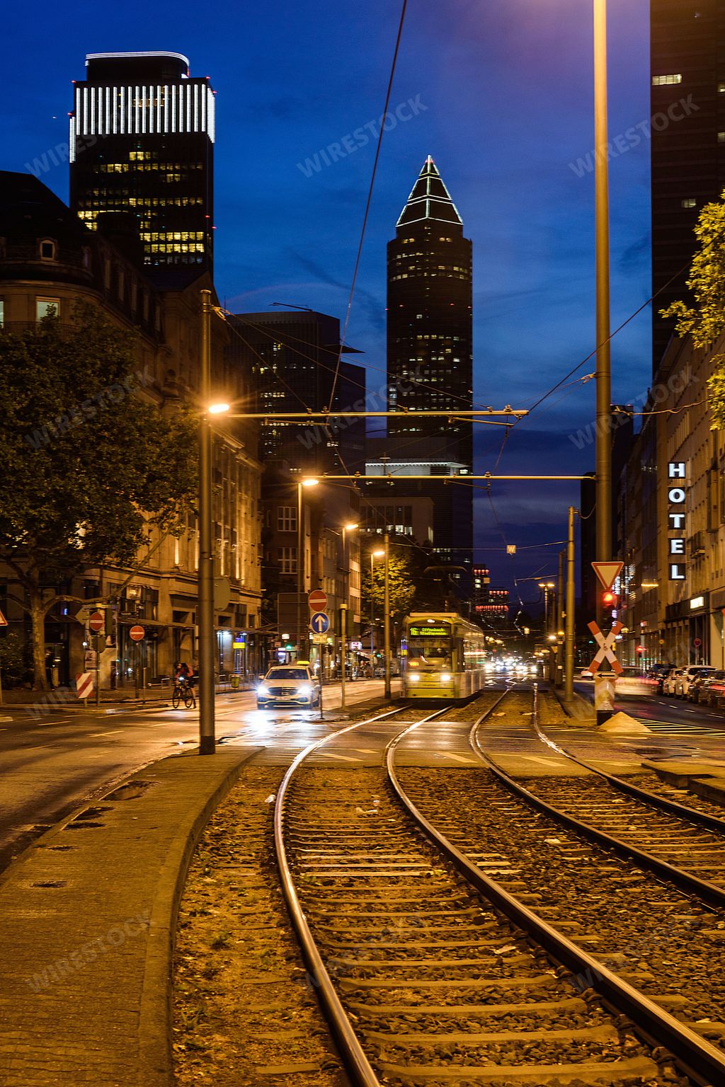 Trams carry tourists and passengers through the city centre of Frankfurt in Germany at night. Slow shutter speed photography