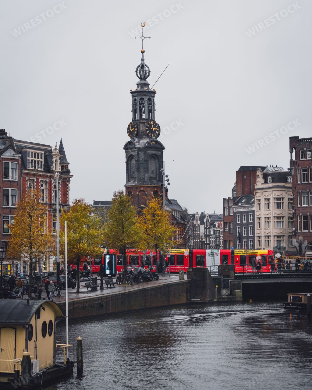 Amsterdam, Netherlands - November 27 2022: Munttoren tower from across the river Amstel on a grey autumn morning.