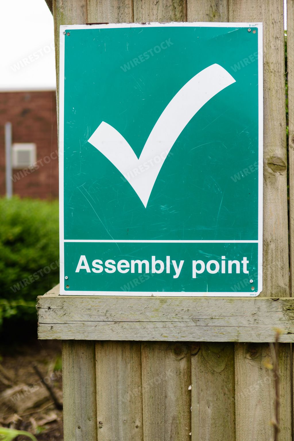 A fire assembly point sign indicates the rendezvous point in case of emergency.