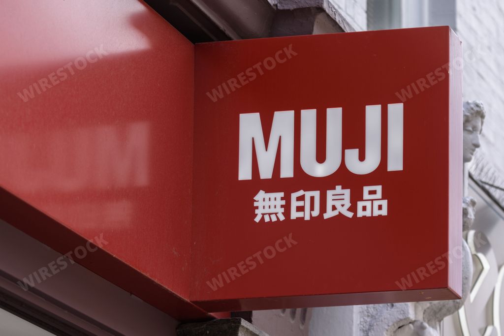 Bright red MUJI sign outside a shop of the popular Japanese retailer in central London.