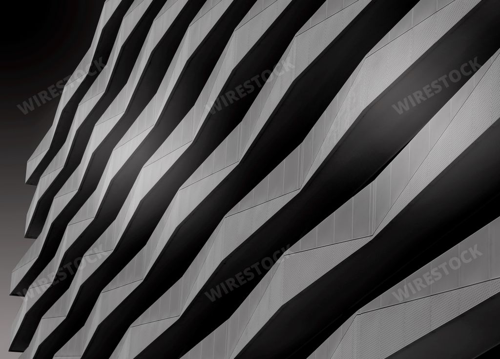 A greyscale shot of the facade of a modern building