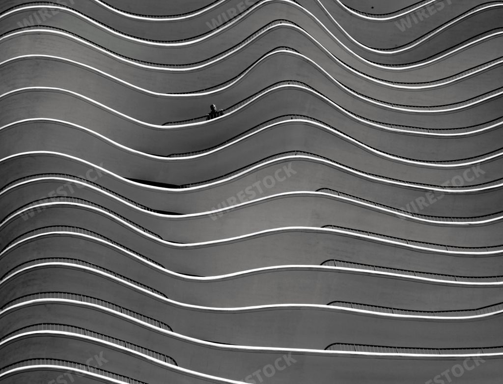 A closeup greyscale shot of a building with curvy twists in Berlin, Germany