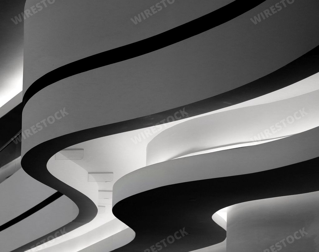 A closeup greyscale shot of a building with curvy twists in Berlin, Germany