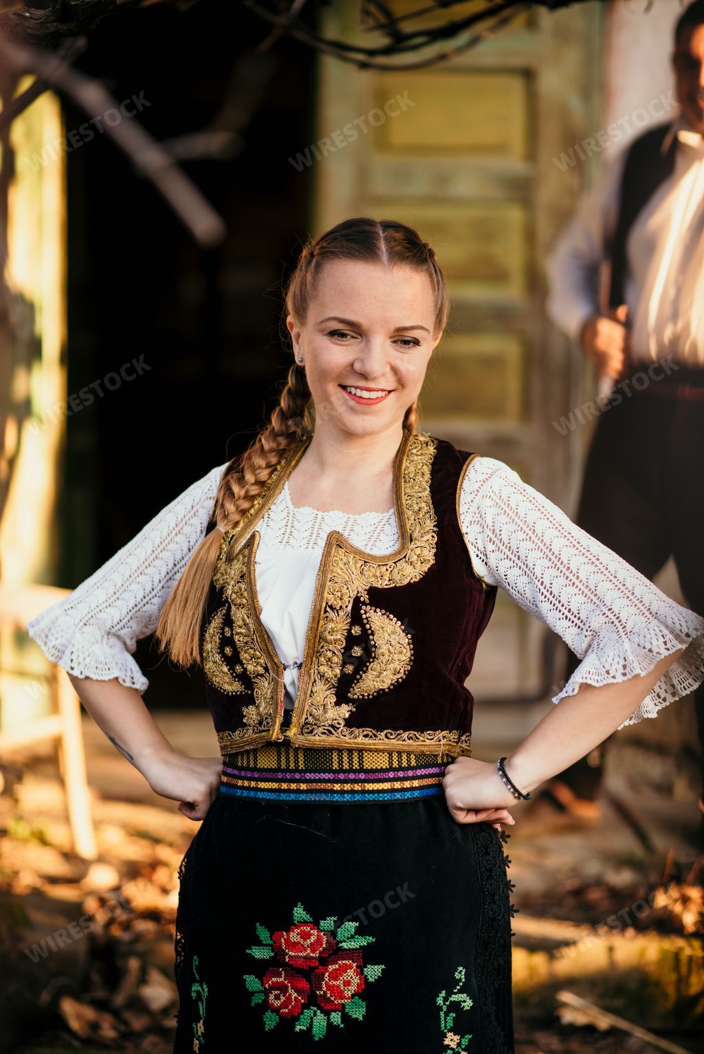 A beautiful shot of a Serbian girl in traditional costume posing for a photo