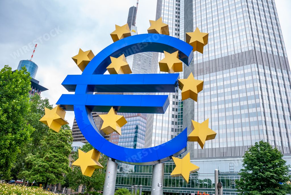 A Low angle of a large euro sign in front of a euro tower in Germany during a cloudy day
