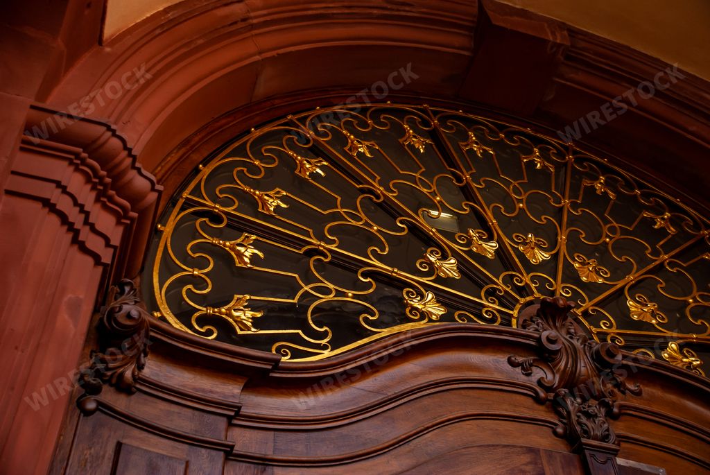 An architectural window above the wooden door in the Mannheim Baroque Palace in Germany